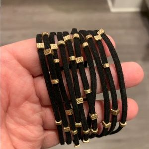 Multi strand black bracelet with gold beads.